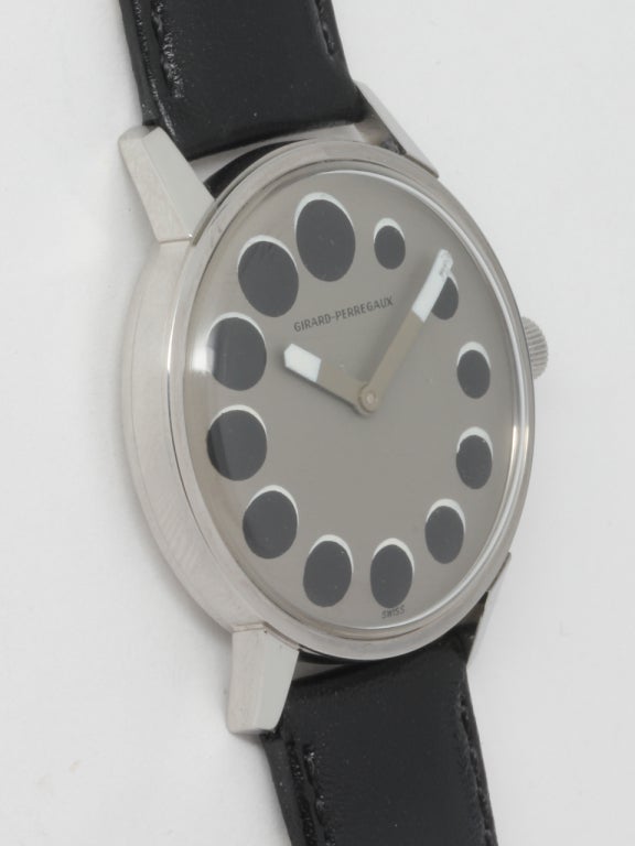 Scarce and distinctive postmodern Girard-Perregaux stainless steel wristwatch with dramatic dial design featuring a dark gray field and graduating size black round indexes with white shadow, resembling a lunar eclipse. Wide stylized hands with white