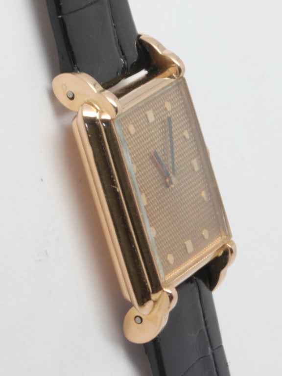 Boucheron lady's 18k yellow gold wristwatch, circa 1990s. 24 X 34mm rectangular case with stepped and sculpted case, and beautiful textured champagne dial with applied indexes. Great looking high-fashion model from this renowned maker. 

Boucheron