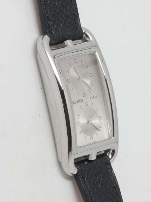 Hermes stainless steel Cape Cod dual time zone wristwatch, Ref. CC3-510, 26 X 47mm, circa 2002, with silvered dials displaying two time zones. Quartz movement, Hermes black leather strap and signed buckle. With original large orange Hermes