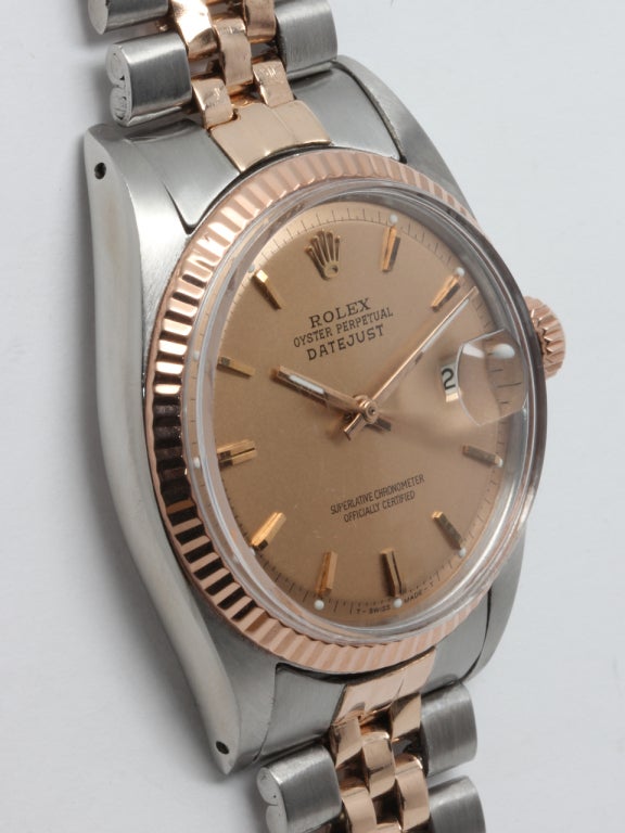 Rolex stainless steel and rose gold Datejust wristwatch, Ref. 1601, serial number 1.4 million, circa 1966. 36mm full size man's model with 14k rose gold fluted bezel, acrylic crystal, and salmon pie pan dial with applied indexes and baton hands.