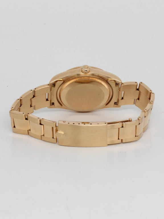 Rolex 18k yellow gold Oyster Perpetual Date wristwatch, Ref. 15238, serial number A8, circa 1998. 34mm diameter case with fluted bezel and sapphire crystal. With original mint condition champagne dial with applied gold indexes. Calibre 3035 movement