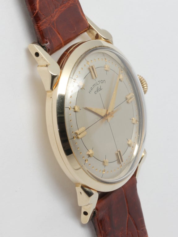 Hamilton 14K gold CLD wristwatch, circa 1950s. Very sharp condition 32mm diameter case with extended stepped art deco style lugs. Beautiful conidtion original two tone silver satin dial with gold applied stylized indexes, minute indicator minute