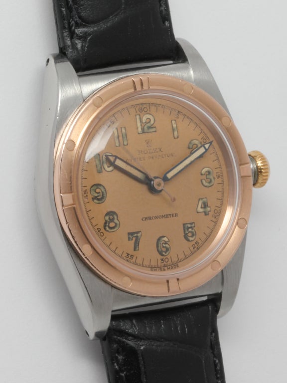 Rolex stainless steel and rose gold Bubbleback wristwatch, Ref. 3372, circa 1940s. 32mm case with excellent condition rose gold engine turned bezel, acrylic crystal, and original patinaed salmon dial with luminous indexes and luminous pencil hands.
