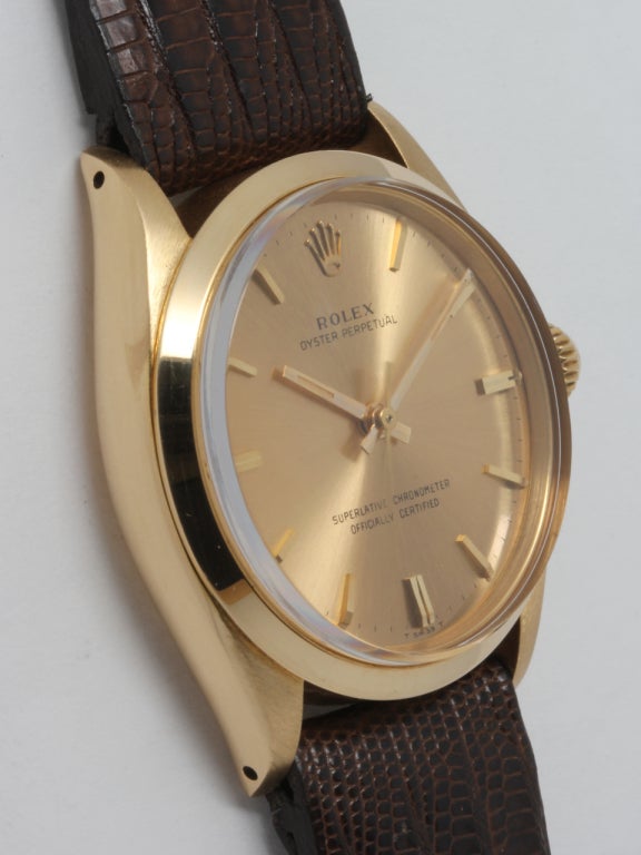 Rolex 18K YG Oyster Perpetual ref# 1002 serial# 1.4 million circa 1967. 34mm diameter case with smooth bezel and acrylic crystal.With beautiful original champagne dial with gold applied indexes and gold baton hands. Powered by Calibre 1570