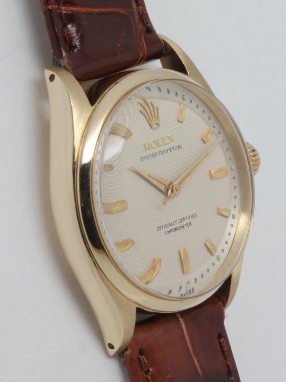 Rolex 14k yellow gold Oyster Perpetual wristwatch, Ref. 6569, serial number 198,XXX, circa 1956. 34mm case with smooth bezel and nicely restored two-piece dial with beveled silvered minutes track and distinctive applied indexes and dauphine hands.