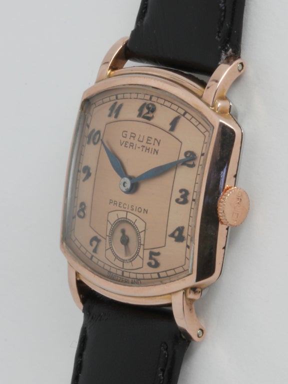 Gruen rose gilt Veri-Thin tonneau wristwatch, 31 X 34mm case with contoured lugs. Original patnaed salmon dial with raised Breguet numerals and blued steel feuille hands. 17-jewel manual-wind movement with subsidiary seconds. On your choice of