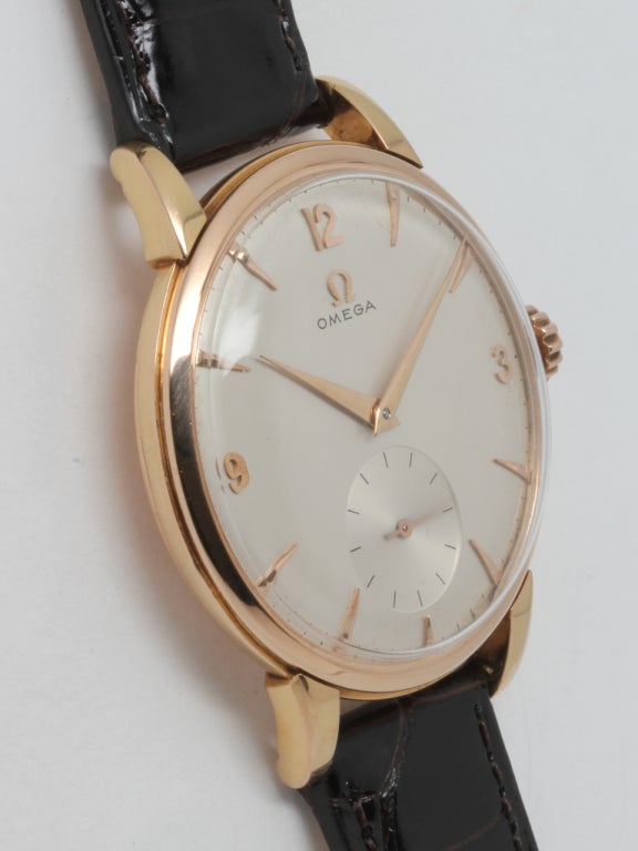 Omega 18k rose gold oversized dress model wristwatch, circa 1950s, 37.5 X 44mm case with extended lugs and matte silvered dial with applied rose indexes and dauphine hands. 17-jewel manual-wind movement with subsidiary seconds. Offered on your