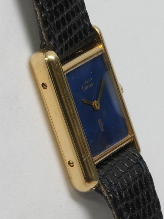 Cartier lady's silver-gilt vermeil (20 microns gold over silver) Must de Cartier Tank Louis wristwatch with lapis dial, circa 1970s. Case secured by four screws. With lapis dial with small gold flakes and gilt hands. 17-jewel manual-wind movement