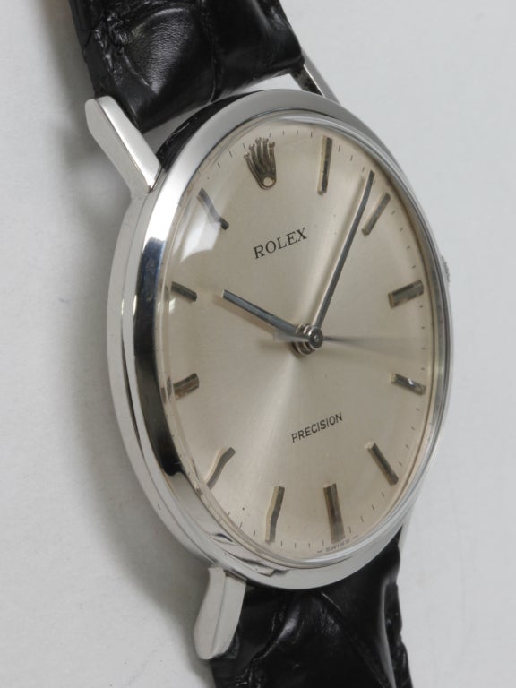 Rolex stainless steel wristwatch, circa 1960s. 33 X 37mm case with straight lugs, acrylic crystal, original silvered satin dial with applied indexes, Rolex logo and baton hands. 17-jewel manual-wind movement with sweep seconds. Shown on black