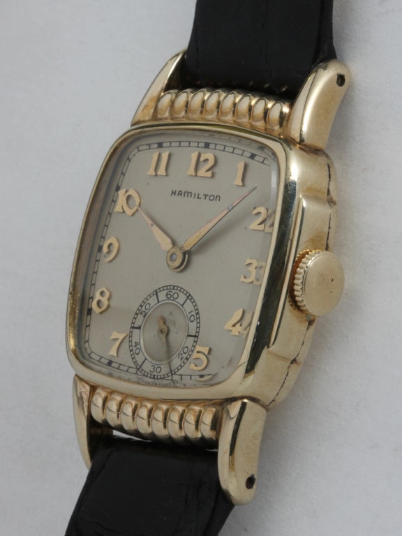 Hamilton gold-filled Russel cushion wristwatch, circa 1930s. 17-jewel manual-wind with subsidiary seconds original matte silvered dial with applied Arabic indexes. Cushion case with ribbed top and bottom. Offered on your choice of fine or leather