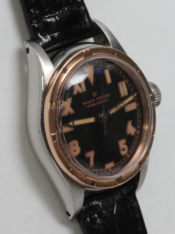 Rolex stainless steel and rose gold Speedking wristwatch, circa 1940s. Boy's size 31mm case with nice condition rose gold engine-turned bezel, beautifully restored glossy black dial with half-Arabic, half-Roman numerals, the so-called 