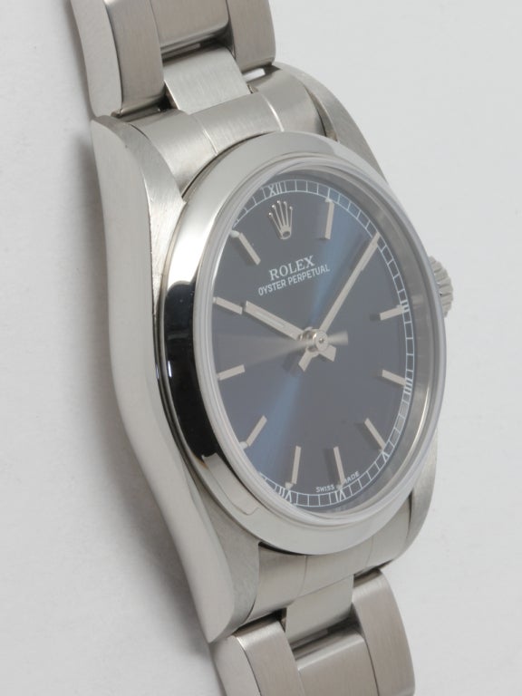Rolex stainless steel midsize Oyster Perpetual wristwatch, Ref. 77080, serial number K2, circa 2000. 31mm diameter case with smooth bezel, sapphire crystal and original blue dial with applied indexes and baton hands. With Rolex stainless steel heavy