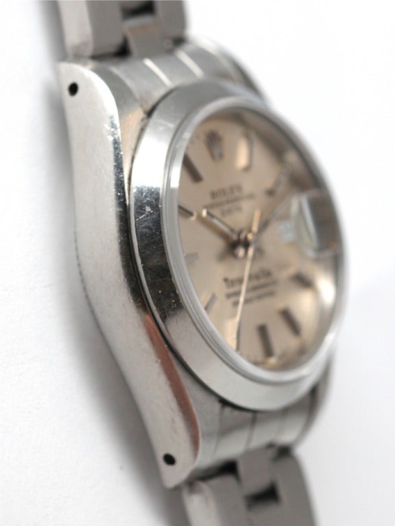 Rolex lady's stainless steel Oyster Perpetual Date wristwatch, Ref. 69160, serial number E4, circa 1990. 27mm case with smooth bezel, sapphire crystal and quikset date. Original silvered satin dial signed Tiffany & Co. With Rolex stainless steel