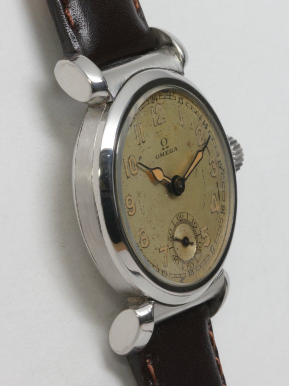 Omega stainless steel wristwatch with extended wishbone lugs, circa 1940s, with original patinaed dial with luminous Arabic indexes and luminous spade hands. This was possibly a military model as it features large luminous numerals and hands, which
