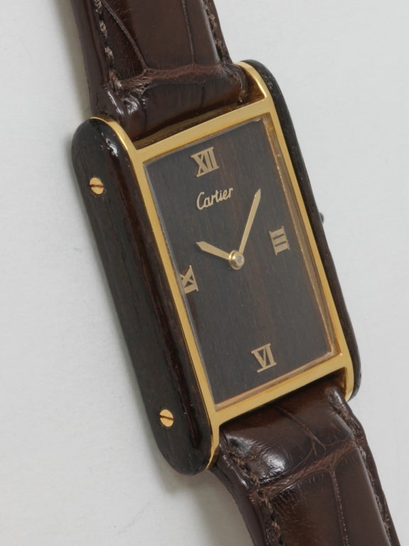 Cartier gilt silver and wood Tank Louis wristwatch, circa 1970s, with wood dial and wood side panels. Applied gilt Roman quarter hours to the dial. 17-jewel manual-wind movement. Offered on high-quality Cartier brown crocodile strap with tang