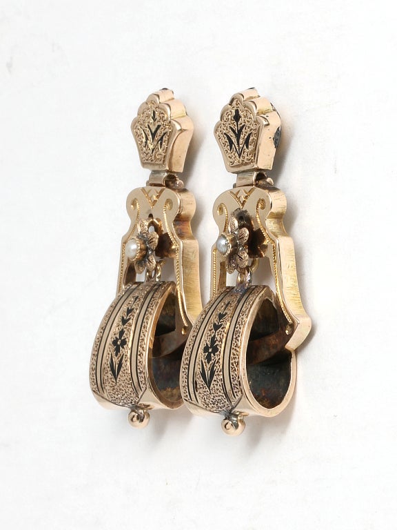 Lovely Victorian era door knocker style 14kt yellow gold earrings, c1880s. Made in 3 articulated sections with a stippled texture, floral black enamel details and accented by a single pearl set flower. Measuring 16.5 x 33 x 6.5mm. Very pretty