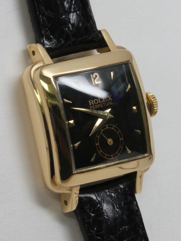 Rolex Lady's 18k yellow gold square wristwatch, Ref. 4663, circa 1950s, with glossy black dial, applied Arabic 12 and dagger indexes and dauphine hands. Great looking 24 x 32mm stepped case to accommodate lady's size automatic movement. Scarce and