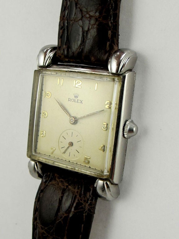 Rolex SS vintage square dress model 27 X 37mm case with large extended claw lugs circa 1950's. Antique white dial with rasied arabic indexes and Rolex logo. 17 jewel manual wind movement with subsidiary seconds. Scarce non round vintage model with