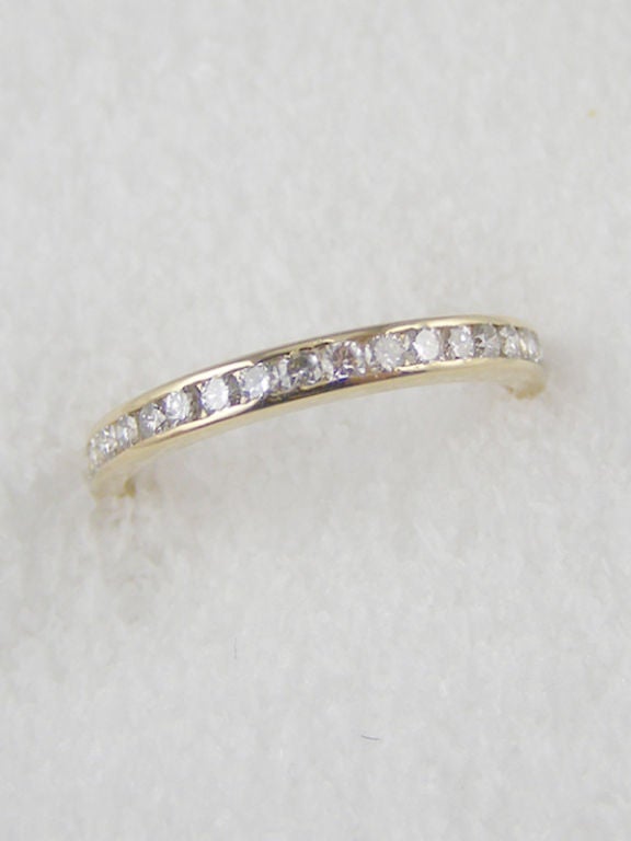 Tiffany & Co signed 18K yellow gold channel set diamond eternity band approximately 0.68 carats total weight, G color and VS2 clarity. 2mm wide, ring size 7.5.

As a special offering for our 1stdibs customers, your purchase will arrive in one of