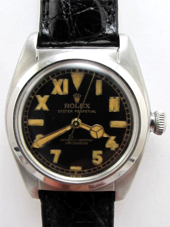 Rolex SS Bubbleback ref # 2940 circa 1940's<br />
with beautifully restored glossy black dial with antiqued luminous indexes<br />
and matching mercedes hands. Self winding NA calibre movement with sweep<br />
seconds. Period bubbleback screw