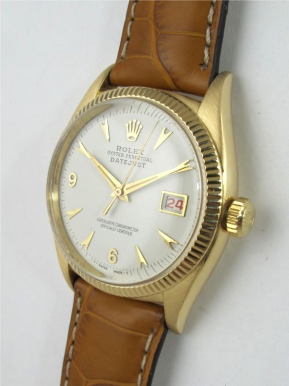 Rolex 18K yellow gold Oyster Perpetual Datejust ref 6305 36mm diameter case with milled bezel circa 1957. Beautifully restored antique white dial with gold applied indexes, tapered gold dauphine hands, and gold framed date window.<br />
Calibre 645