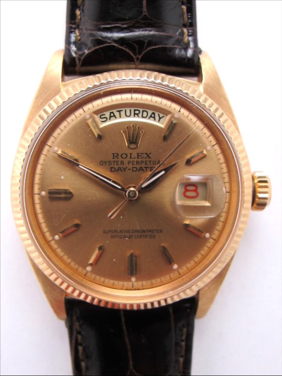 Rolex 18K PG day date President ref. 6611 36mm diameter case with fluted bezel serial # 214,xxx circa 1957 with very beautiful antique salmon dial with PG applied indexes. Calibre 1055 self winding movement with red date wheel and sweep seconds. On