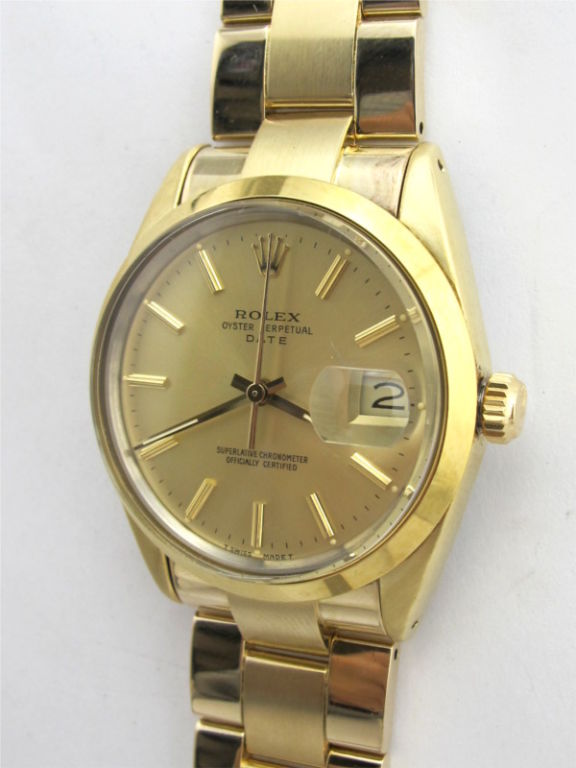 Rolex gold shell Oyster Perpetual Date ref #15505 34mm diameter case with smooth bezel serial #: 9.0 million circa 1985/86. Featuring an original and mint condition champagne dial with gold applied indexes and gold baton hands. Self winding calibre
