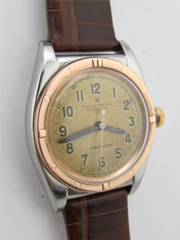Rolex SS/PG Bubbleback ref #2764 with warmly patina'd original luminous salmon dial circa 1940's with PG engine turned bezel and pink gold period screw down crown. Very pleasing vintage example with pleasing patina'd antique salmon dial with