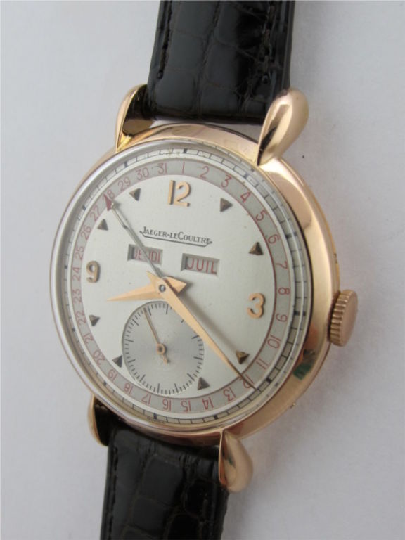 Lecoultre 18K PG triple calendar oversized dress model 36 X 45mm case with large lobed lugs circa 1950's. Magnificent condition case, and original mint 2 tone satin dial with red calendar ring and, gold applied indexes, original tapered pink gold