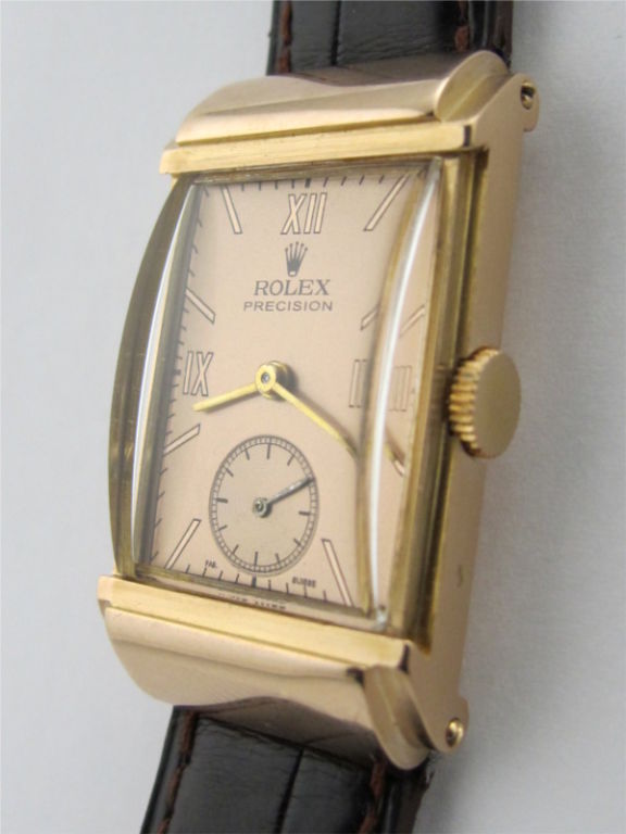 Rolex 18K PG Hooded Rectangle high style French made and hallmarked case circa 1940's post WWII era. Rare and gorgeous model 22 X 38mm with stepped design and hooded lugs. Scarce and beautiful. With French hallmark 18K YG buckle.<br />
Stk# 39610