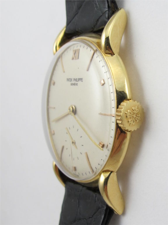 Patek Philippe 18K YG large dress model ref # 1595 grasshopper lugs circa 1946. Silver satin dial with gold applied indexes.18 jewel manual wind movement with subsidiary seconds. Very pleasing man's dress Patek.<br />
Stk# 39461