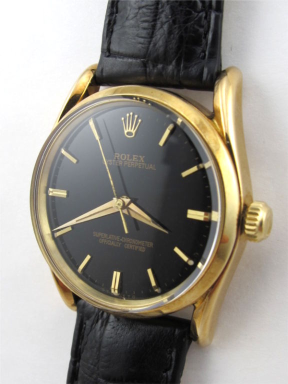 Rolex 14K YG Oyster Perpetual Bombe case ref# 1010 serial # 646,XXX circa 1961. 33mm diameter case with heavy and stylish turned in lugs, glossy black original dial with subtle tapered applied gold indexes and tapered dauphine hands. Calibre 1560