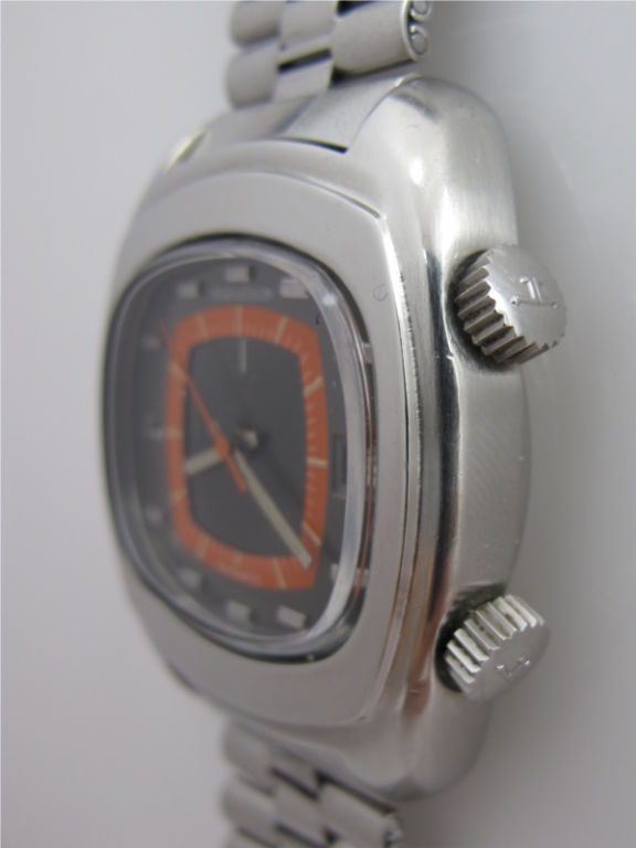 Jaeger Lecoultre SS TV screen shaped alarm model circa 1970's with beautiful original orange and charcoal dial with applied silver indexes and silver baton hands. Self winding movement with sweep seconds and date and alarm. Signed original crowns.