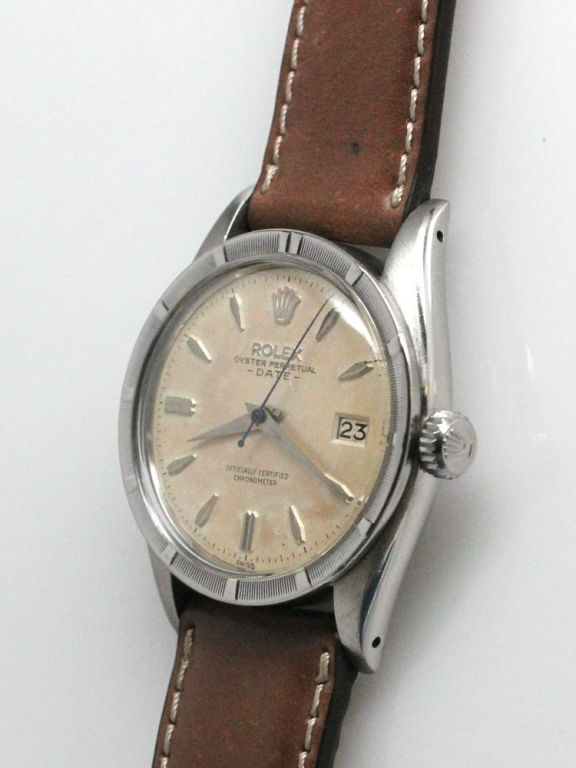 Rolex SS Oyster Perpetual Date ref 6534 serial # 410,,xxx circa 1959. 34mm diameter case with textured engine turned bezel and original antique white dial with applied stylized indexes and tapered dauphine hands. Calibre 1030 self winding movement
