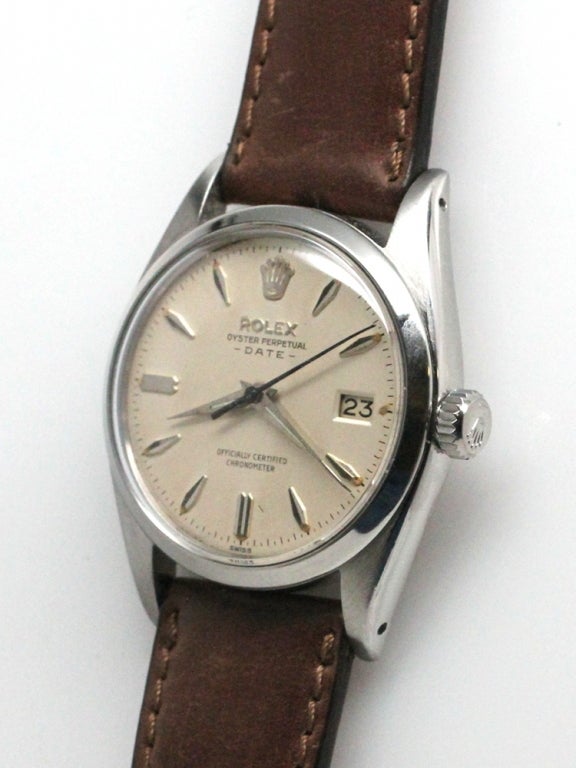 Rolex SS Oyster Perpetual Date ref 6534 serial # 405,,xxx circa 1959. 34mm diameter case with smooth bezel and original antique white dial with silvered marquise shaped indexes and tapered dauphine hands. Calibre 1030 self winding movement with