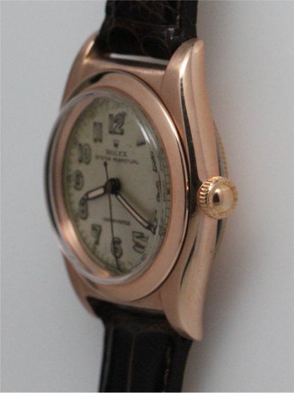 Rolex 14K pink gold bubbleback ref 3131 circa 1940's with orginal patina'd silver satin dial with luminous indexes and pencil style hands. Sharp condition original case and screw down crown. Great looking classic man's model for either sex. Offered
