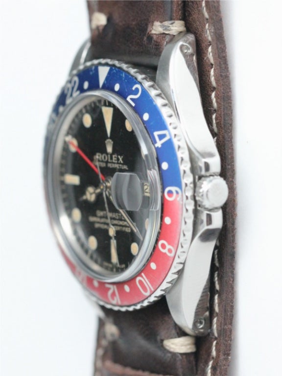 Rolex SS GMT ref 1675 serial # 1.3 million circa 1966 with very pleasing original glossy black gilt print dial with patina'd luminous indexes and hands. 24 hour mini hand. Faded red and blue so called Pepsi bezel. Very pleasing vintage model offered