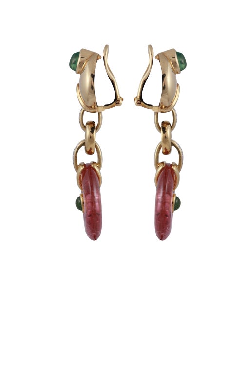 Pair of 18k yellow gold, pink tourmaline and peridot earrings. The top portion of the earring is a teardrop gold shape  set with a cabochon emerald. Connected by a diamond circle chain , a pink tourmaline disc drop is suspended, with a cabochon