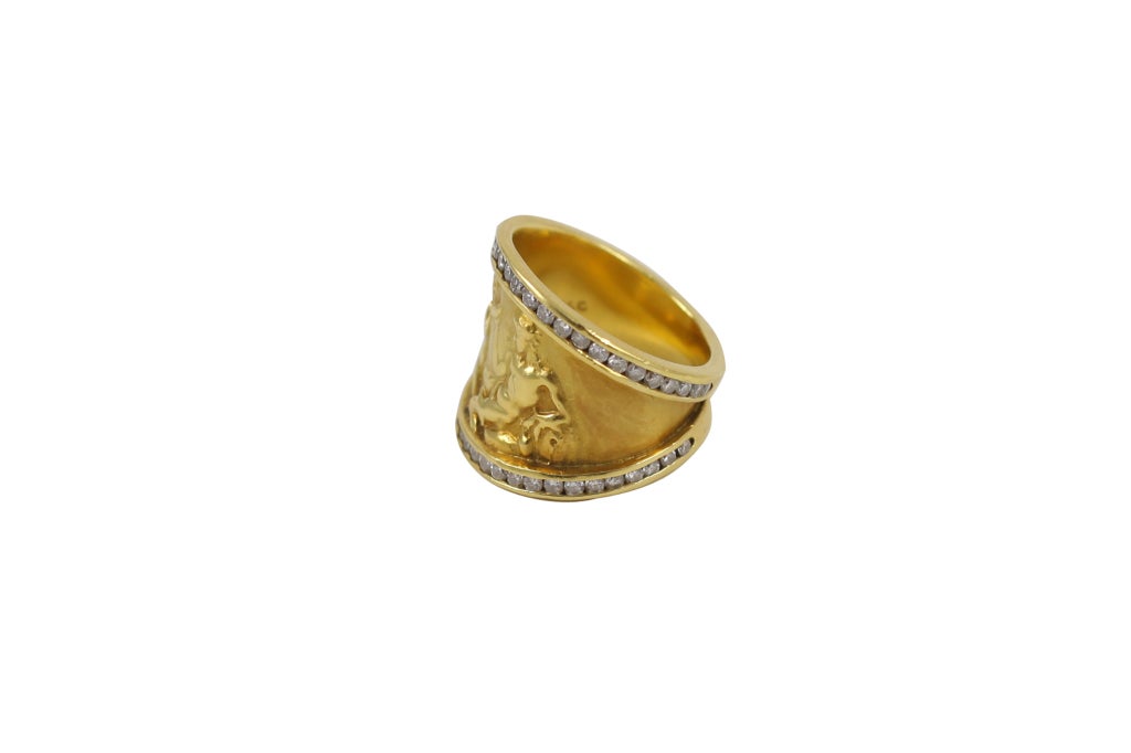 18K yellow gold and diamond Odyssey band ring. Greek scene depiction across the ring, with diamond detail around the band. Approximately 1.12cts.
