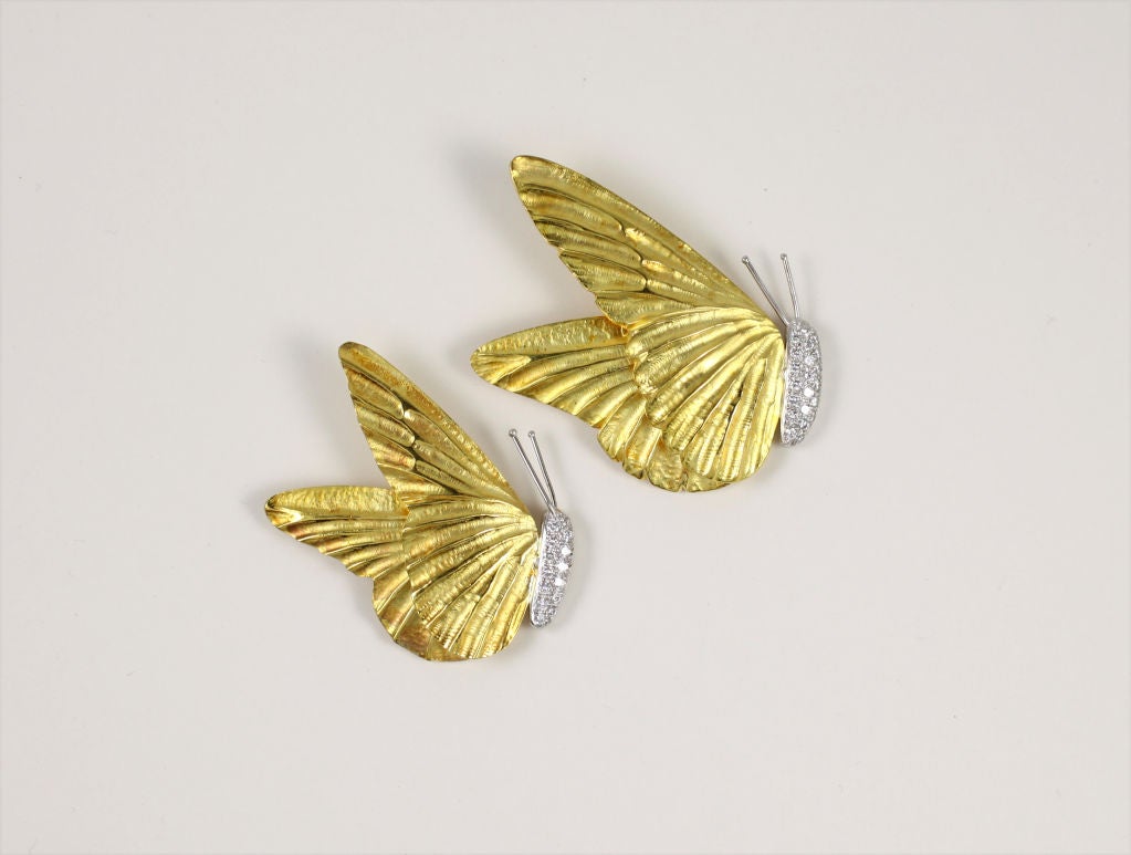 “Marlene Stowe” Set of two 18k yellow gold and platinum butterfly pin designed pins. Small butterfly contains .32ct of diamonds and larger contains .68ct of round brilliant cut diamonds.