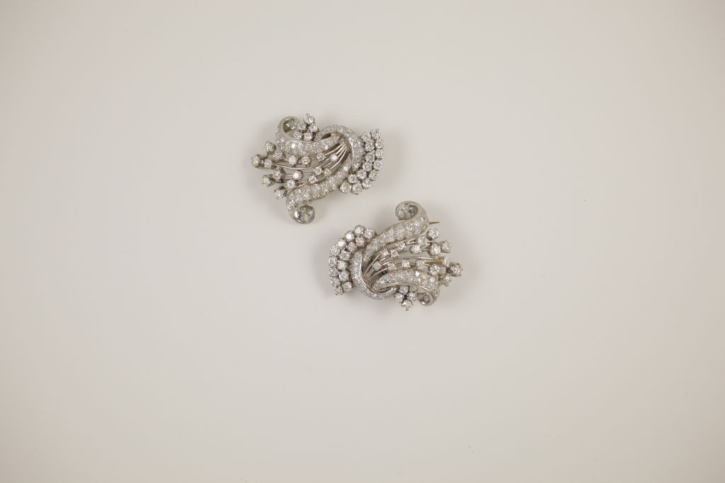 Pair of platinum and diamond pins with a floral basket motif with diamonds that are prong and bead-set. Piece comprised of 35 round brilliant diamonds(5.0ctw) and 65 round brilliant diamonds (1.30ctw). The piece comes with a mate to combine the two
