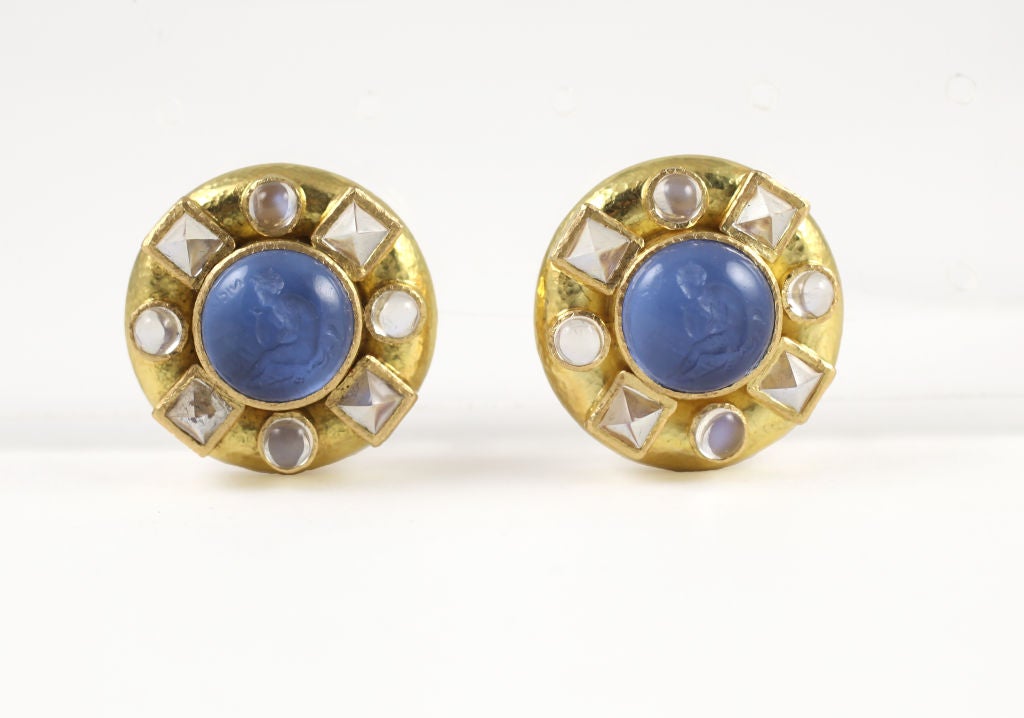 “Elizabeth Locke” 18k yellow gold venetian glass and moonstone earrings. Each earrings features an intaglio of “Nico” and is surrounded by sugarloaf-cut and cabochon moonstones. Each earring features a collapsible post with omega back.