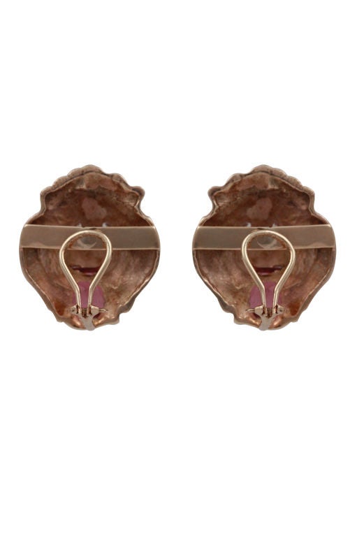 14k yellow gold cast lion’s head earrings with clip-backs. In the mouth of each is a scissor-cut purple tourmaline measuring approx. 12.8mm x 9.5mm x 6.5mm approx 6ct each. Each lion also has one round brilliant diamond in each eye, est total weight