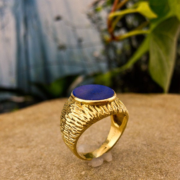 Made in 18k yellow gold and centered with an oval cut lapis lazuli stone. Originally designed for a man but we feel this ring is unisex. Size 81/4*<br />
<br />
*can be sized