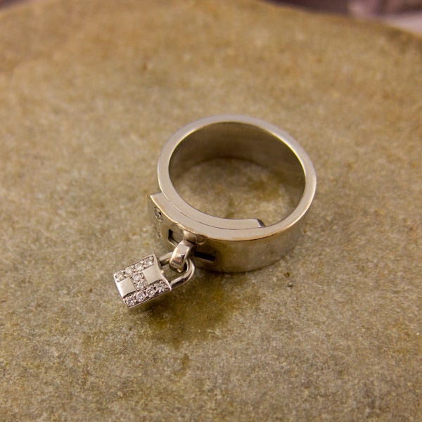 This is a rare Hermes white gold and diamond ring. The lock on the ring has the luxurious H for Hermes in diamonds. Fits comfortable for everyday wear. Size 4.5*<br />
<br />
*can be sized<br />
<br />
Signed Hermes and numbered