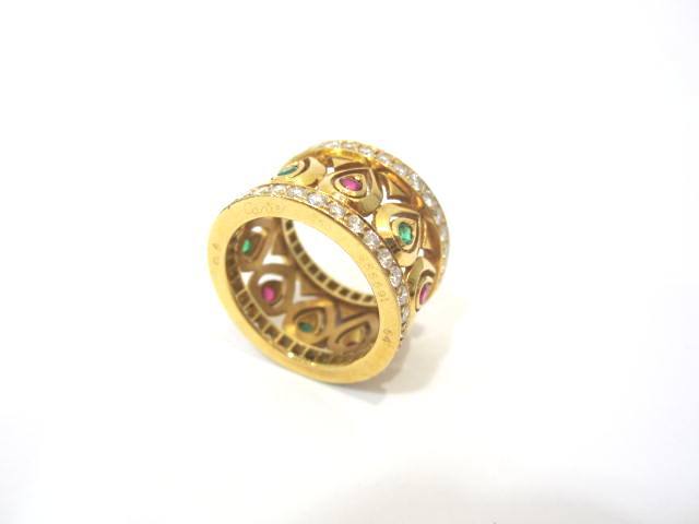 This elegant Ring is signed by CARTIER and is crafted in 18K Yellow Gold.  It is embellished with Ruby, Sapphire, Emerald and Diamonds.Size 7.