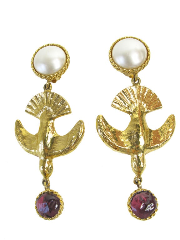 CHANEL large swallow earrings with purple glass stone and faux pearls. Condition: Very good, very minor wear to faux pearls.<br />
<br />
WWW.ARCHIVEVINTAGE.COM