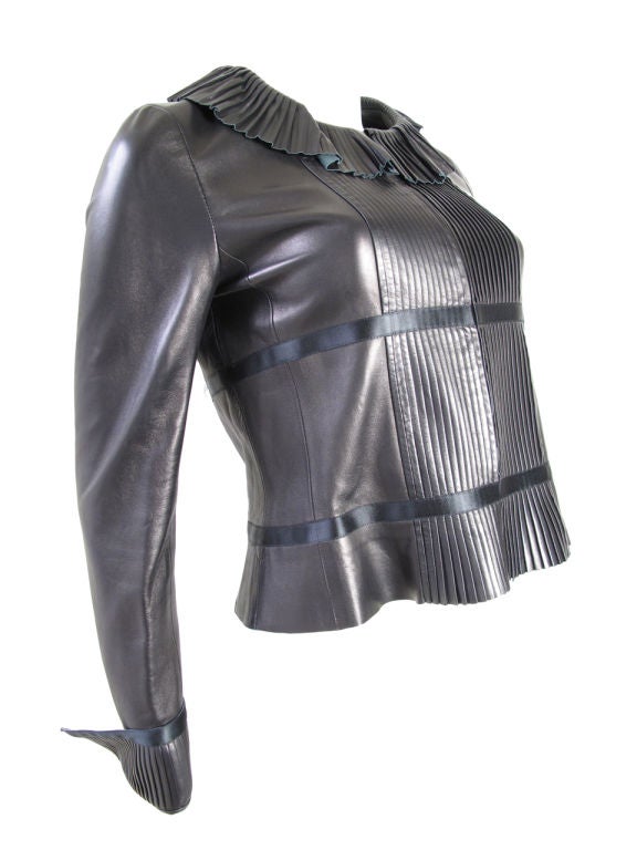 CHANEL black leather jacket with ruffle collar and pleated front. <br />
35