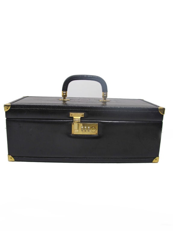 1970s black leather GUCCI jewelry travel case with lizard trim. <br />
<br />
Interior roll case . Exterior combination lock. <br />
<br />
Condition: some damage to exterior top and bottom. 14 1/4