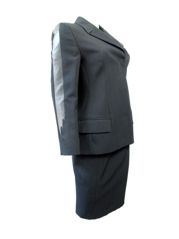 Gianni Versace black wool suit with black leather flames on sleeves. Circa 1998. Condition: Excellent. Jacket: 35